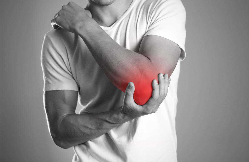 6 Benefits of Physical Therapy for Arthritis Patients - Man Holding Elbow in Pain.